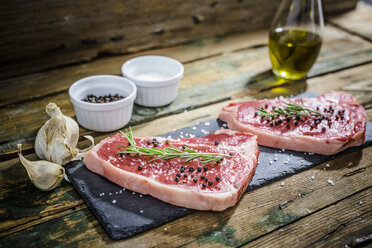 Raw beefsteak with rosemary, salt and pepper - GIOF03691