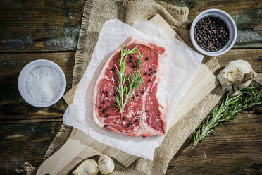 Raw beefsteak with rosemary, salt and pepper - GIOF03692