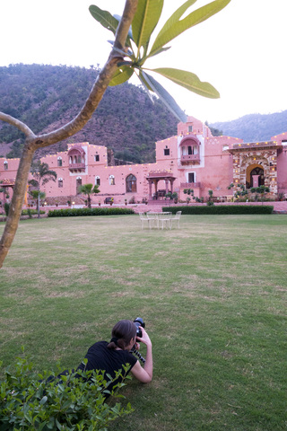 India, Rajasthan, Alwar, female tourist photographing Heritage Hotel Ram Bihari Palace stock photo