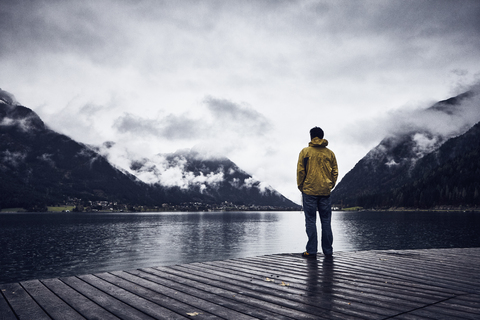 Austria, Tyrol, Lake Achen, man standing on boardwalk stock photo