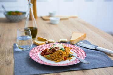 Spaghetti with cherry tomatoes and basil on a plate - GIOF03718