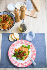 Spaghetti with cherry tomatoes and basil on a plate - GIOF03721