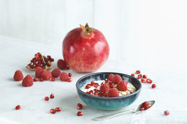 Bowl of fruit muesli with raspberries and pomegranate seed - ASF06137