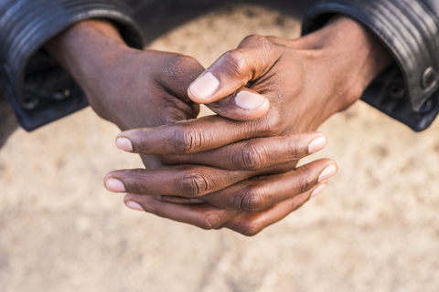 Young north african man, hands folded stock photo