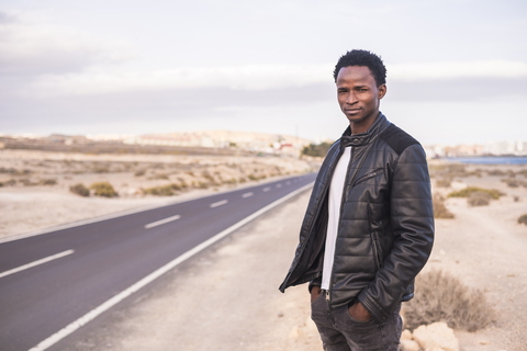 Spain, Tenerife, young man standing on road stock photo