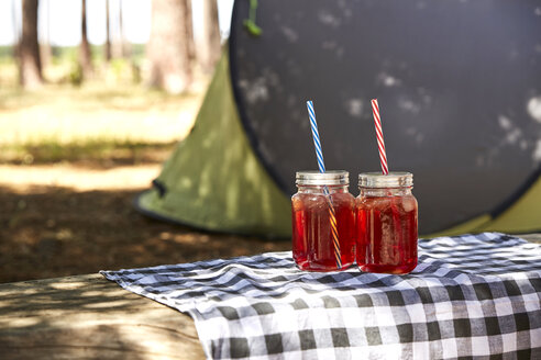 Glasses with juice and drinking straws - SRYF00586