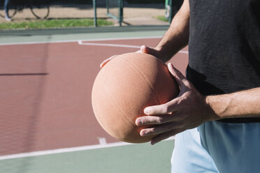 Man holding basketball - ALBF00317