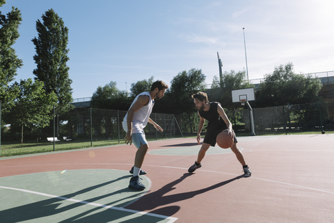 Men playing basketball stock photo