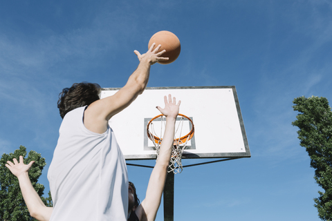 Men playing basketball stock photo