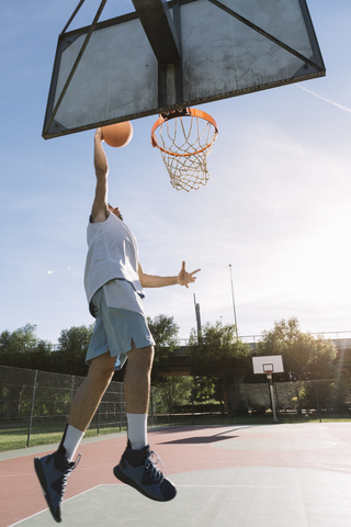 Man playing basketball stock photo