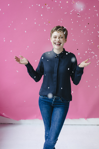 Confetti falling on happy woman stock photo