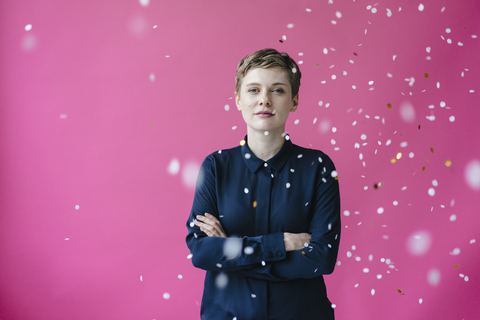 Confetti falling on confident woman stock photo