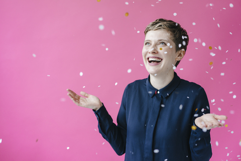 Confetti falling on happy woman stock photo