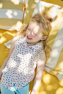 Glückliches Mädchen auf einer Decke liegend - SRYF00596
