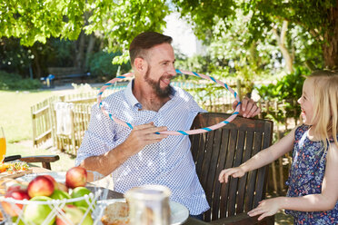 Happy girl with father having fun in garden with hoop - SRYF00623