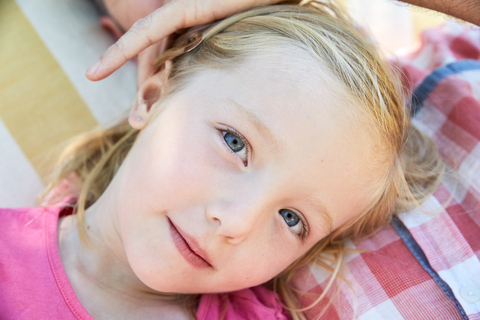 Portrait of smiling girl relaxing with father stock photo