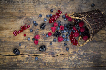 Wickerbasket of various berries on wood - LVF06565