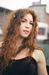 Porträt einer rothaarigen jungen Frau mit Schneeflocken im Haar - FCF01327