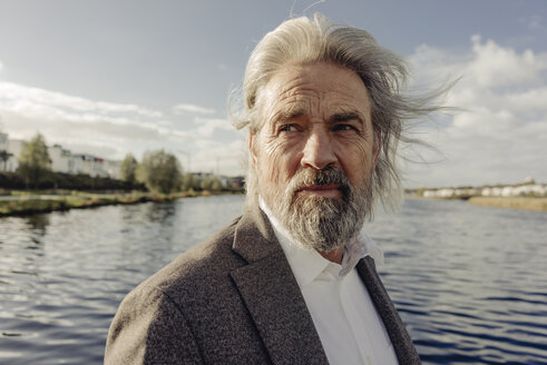 Portrait of serious senior man at a lake - KNSF03333