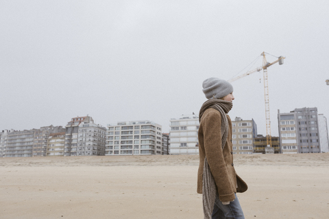 Germany, North Sea Coast, boy strolling on the beach in winter stock photo