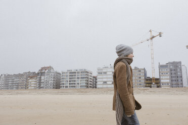 Germany, North Sea Coast, boy strolling on the beach in winter - KMKF00101