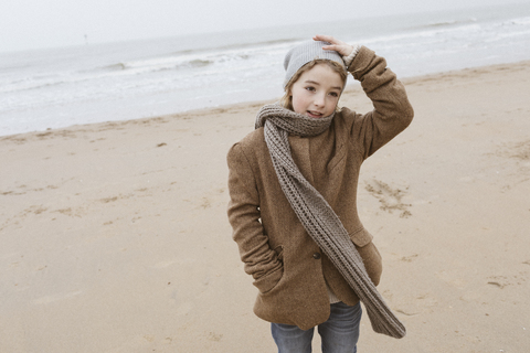 Portrait of boy standing on the beach in winter stock photo