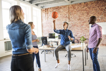 Colleagues playing basketball in office - HAPF02623