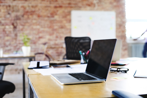 Laptop on table in office stock photo