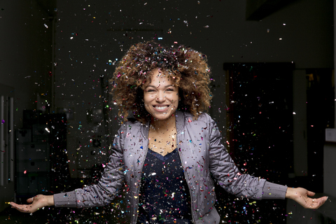 Confetti falling on happy woman stock photo