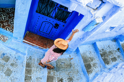 Morocco, Chefchaouen, woman walking alley downwards, top view stock photo