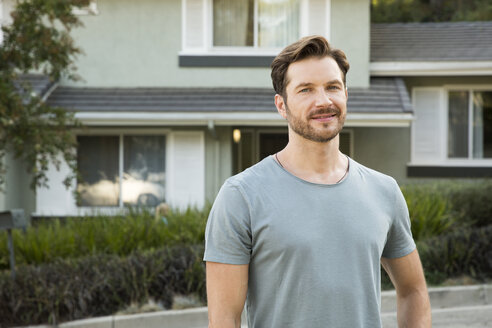 Portrait of confident man in front of his home - MFRF01130