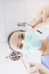 Personal perspective of female dentist with mask at work - MMAF00214