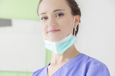 Portrait of smiling female dentist with mask - MMAF00216