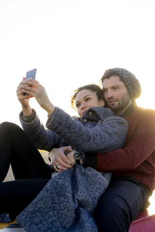 Junges Paar nimmt Selfie im Freien, lizenzfreies Stockfoto