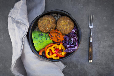 Lunch bowl of quinoa, red cabbage, bell pepper, avocado, quinoa fritters, ajvar and black sesame - LVF06571