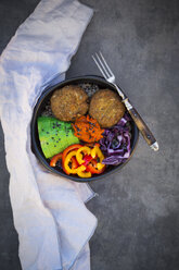 Lunch bowl of quinoa, red cabbage, bell pepper, avocado, quinoa fritters, ajvar and black sesame - LVF06572