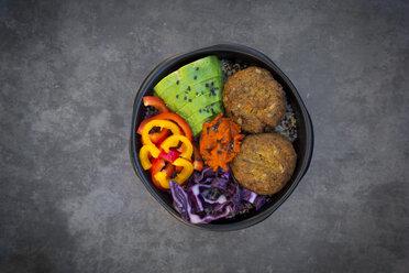 Lunch bowl of quinoa, red cabbage, bell pepper, avocado, quinoa fritters, ajvar and black sesame - LVF06574