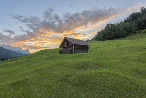 Germany, Bavaria, Werdenfelser Land, hay barn at sunrise - RPSF00077