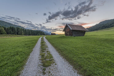 Germany, Bavaria, Werdenfelser Land, hay barn at sunrise - RPSF00079