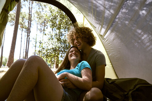 Happy young couple embracing in a tent - SRYF00717
