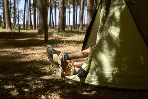 Shoes are sticking out of a tent in forest - SRYF00718