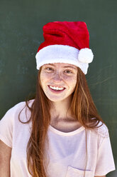 Porträt einer lächelnden jungen Frau mit Weihnachtsmütze - SRYF00762