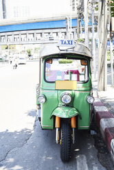 Thailand, Bangkok, green tuk-Tuk vehicle parked on the stree - IGGF00342