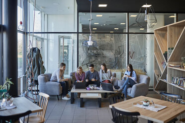 Group of friends sitting together in a cafe with laptop - ZEDF01047