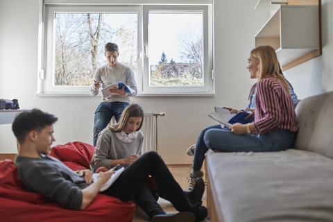 Group of students in dormitory learning together stock photo