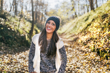 Portrait of a beautiful happy woman in an autumnal forest - MGOF03709