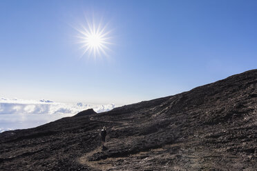 Reunion, Reunion National Park, Shield volcano Piton de la Fournaise, female tourist hiking to crater - FOF09648