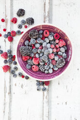 Bowl of deep frozen red currents, rapsberries and blackberries - LVF06595