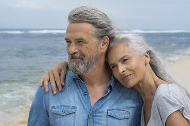 Handsome senior couple embracing at the beach - SBOF01076