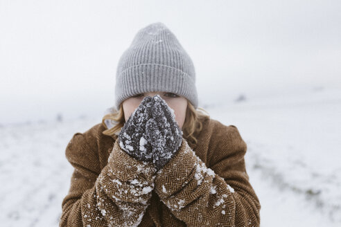 Boy in snow warming his hands - KMKF00124